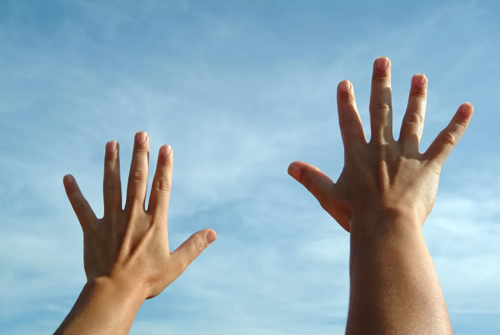 Person reaching up towards hope and recovery from gambling addiction